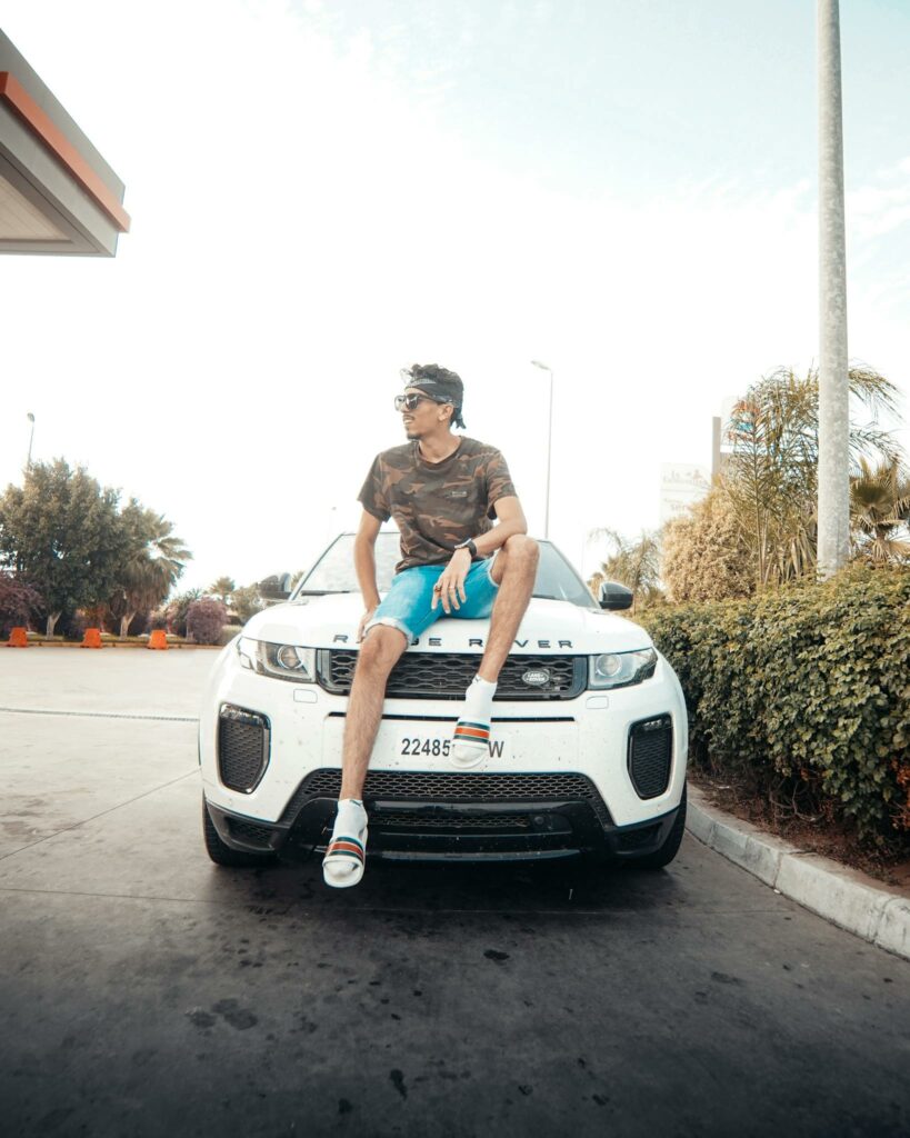 Photo by Mohamed Boumaaz Photo of Man Sitting on White Range Rover